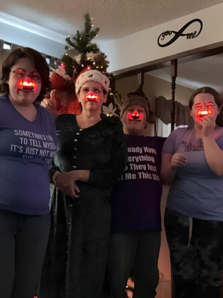 Family of four wearing NoMore® Colds devices together, showing Eric Spear’s review about buying a 4-pack and solving his family’s allergies
